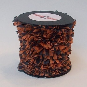 May include: A spool of black and orange shredded paper trim. The trim is approximately 10 inches wide and is perfect for adding a festive touch to crafts and decorations.