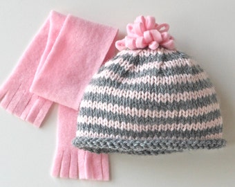 American Girl doll hand-knit hat and scarf set. Hat is pink & gray striped wool w/ fleece pom pom. Coordinating scarf in pink fleece.