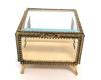 Vintage Beveled Glass Box with Ornate Gold Tone Metal Edges, Raised Feet, Hinged Lid, & Yellow Fabric Lined Interior