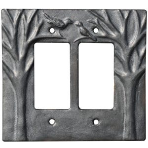 Peut inclure: Plaque de protection d'interrupteur double en métal moulé gris foncé. La plaque présente un motif d'arbre sur les côtés et deux oiseaux en haut. Elle comporte deux ouvertures rectangulaires pour les interrupteurs et quatre trous de vis.