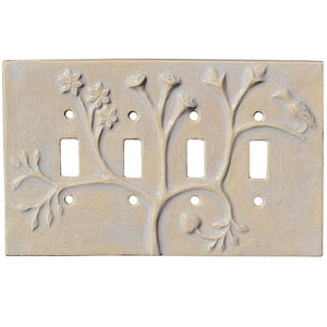 May include: A beige ceramic light switch cover with a raised tree design. The tree branches feature flowers, buds, and a bird. The cover has four switch openings and is a decorative home accent.