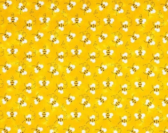 May include: A yellow fabric with a repeating pattern of white bees flying in a circle. The bees have black eyes and black stripes.