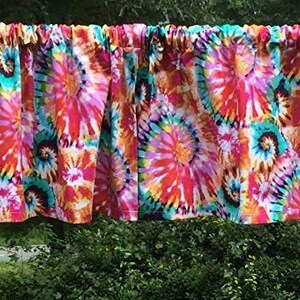 K&ouml;nnte beinhalten: Eine bunte Binde mit einem wirbelnden Muster in den Farben Pink, Orange, Blau und Gelb.