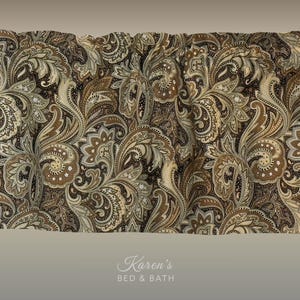 May include: A window valance featuring a dark brown background with an intricate, repeating paisley pattern in shades of tan, cream, and light brown. The fabric is gathered at the top for a pleated effect. The text Karen's BED & BATH is visible.