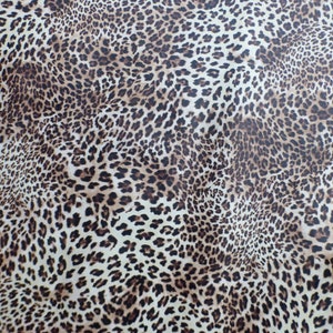 May include: A brown and white leopard print fabric with a subtle sheen. The fabric has a repeating pattern of brown spots on a white background.