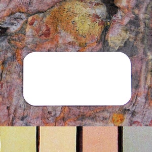 May include: A white rectangular label with rounded corners, set against a background of textured, multi-colored rock.