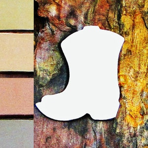 May include: White cutout of a cowboy boot shape on a rustic wooden background.