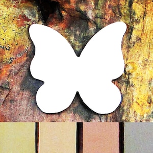 May include: A white butterfly cutout with a rustic background. The butterfly is a simple shape with no details. The background is a mix of brown, orange, and yellow.