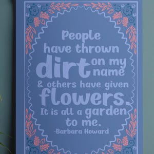 May include: A blue wall hanging with the quote "People have thrown dirt on my name & others have given flowers. It is all a garden to me." in white text. The quote is surrounded by a pink and teal floral border.