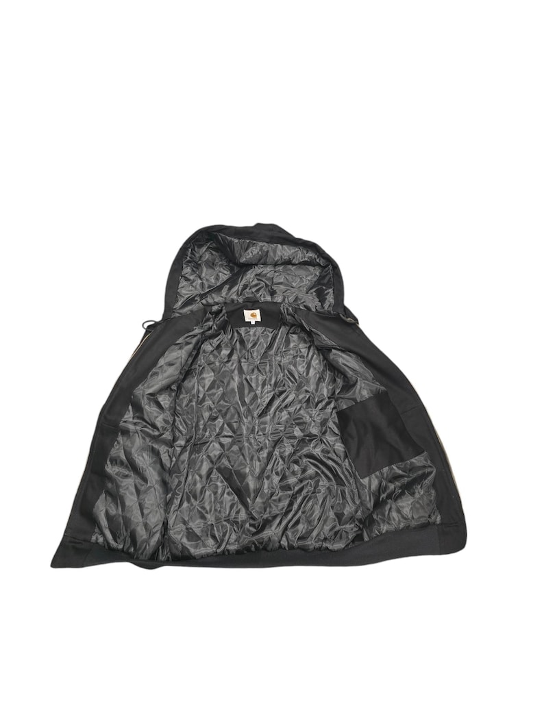 May include: Black hooded jacket with a zipper closure and a quilted lining. The jacket has a pocket on the inside.