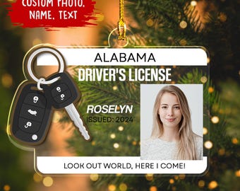 May include: A clear acrylic ornament shaped like an Alabama driver's license, featuring a photo, the name "Roselyn," and the issue year 2024. The ornament includes a car key design and the text "LOOK OUT WORLD, HERE I COME!"