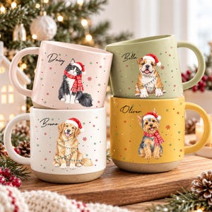 May include: Four ceramic mugs in pastel pink, sage green, yellow, and white, each featuring a festive illustration of a dog or cat wearing a Santa hat and scarf, with the names Daisy, Bella, Bruno, and Oliver printed above the animals.