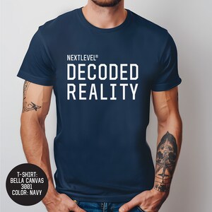 May include: A navy blue t-shirt with the text "NEXTLEVEL® DECODED REALITY" printed in white.