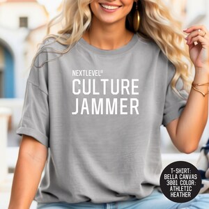 May include: A heather grey t-shirt with the text "NEXTLEVEL® CULTURE JAMMER" printed in white.