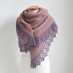 May include: A purple and peach striped knitted shawl with a crocheted lace border.