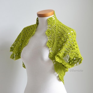 May include: A lime green crochet bolero featuring an intricate openwork floral pattern with short sleeves and a scalloped edge. The garment is displayed on a white mannequin and includes the text Berniolie printed in the bottom right corner.