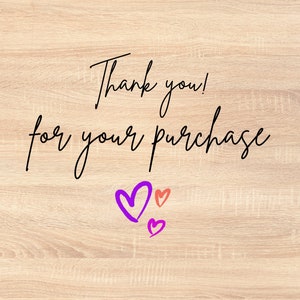 May include: Thank you! for your purchase. The text is written in black cursive font on a light wood background. There are three hearts drawn in the bottom right corner of the image. One heart is purple, and two are pink.