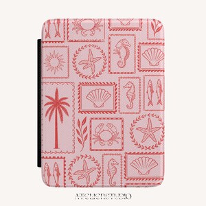 May include: A light pink e-reader case featuring a repeating pattern of red line-art illustrations of sea life, including crabs, seahorses, starfish, seashells, palm trees, and fish, all framed within rectangular or circular borders.