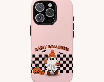 May include: A light pink phone case featuring a ghost wearing an orange beanie, holding a drink and a pumpkin bucket. The design includes two jack-o'-lanterns, a black and white checkerboard pattern, bats, and the text HAPPY HALLOWEEN in orange.