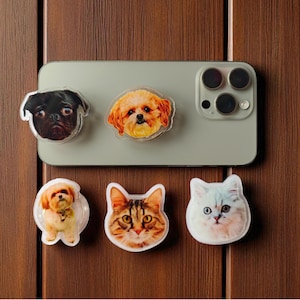May include: A selection of clear, circular magnets showcasing detailed portraits of dogs and cats. The dog magnets feature a pug and a fluffy brown and tan dog. The cat magnets include a tabby and a white cat with blue eyes.