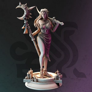 May include: A white painted figurine of a female elf warrior holding a crescent moon staff and a sword. She is wearing a flowing skirt and a jeweled belt. The figurine is standing on a circular base with candles.