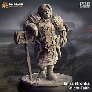 May include: A miniature figurine of a female knight in full armor, holding a large hammer. She has long, flowing hair and a determined expression on her face. The figurine is painted in a gray color and is standing on a circular base. The text "Enira Stronka Knight-Faith" is printed below the base.