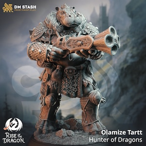 May include: A gray, detailed miniature figurine of a hippopotamus-like creature wearing armor and holding a multi-barreled gun. The figurine is standing on a base with the text "Rise of the Dragon" and "Olamize Tartt Hunter of Dragons".