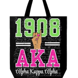 May include: Black tote bag with the text "1908" in green, "AKA" in pink, and "Alpha Kappa Alpha" in white. The design includes a hand gesture with pink fingernails. The bag has black handles.