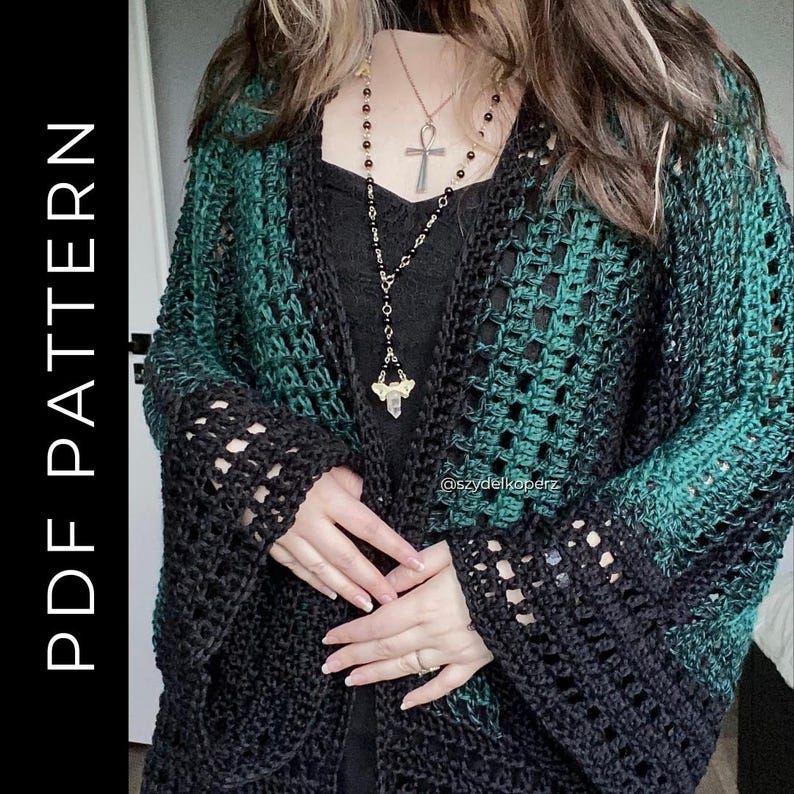 May include: A black and green crochet cardigan with openwork sleeves. The cardigan has a gradient effect, transitioning from black to green. The text "PDF PATTERN" is visible on the left side of the image. The cardigan is open in the front.