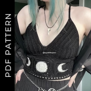 May include: A black crochet crop top featuring a deep V-neckline and thin straps. The bottom section displays a white moon phase design with a crescent moon, a full moon, and another crescent moon. The text PDF PATTERN is visible on the left.