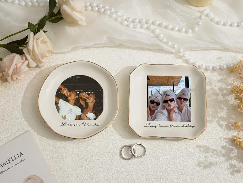 May include: Two decorative ceramic dishes with gold rims. One round dish features a photo of people drinking, with the text "Love you Yolanda." The other square dish has a photo of three people, with the text "Long live friendship."