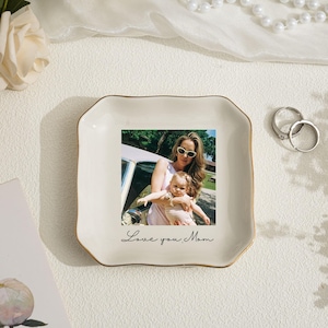 May include: A set of three ceramic mugs with a speckled, matte finish. The mugs are in shades of cream, light gray, and dark gray. Each mug has a simple, minimalist design, suitable for coffee or tea.