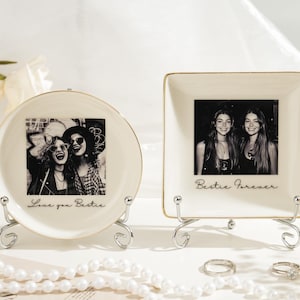 May include: Two ceramic photo holders, one round and one square, each with a black and white photo of two people. The round holder says "Love you Bestie" and the square holder says "Bestie Forever". Both are on decorative metal stands.