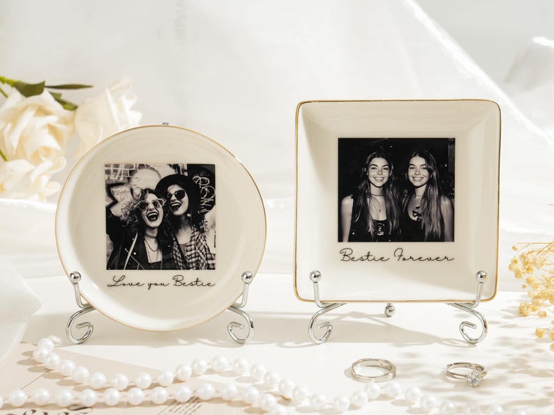 May include: Two ceramic photo holders, one round and one square, each with a black and white photo of two people. The round holder says "Love you Bestie" and the square holder says "Bestie Forever". Both are on decorative metal stands.