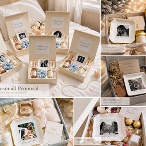 May include: A collection of gift boxes featuring personalized ceramic trinket dishes with printed photographs, small bottles of sparkling wine, scented candles, jewelry, and fabric hair scrunchies, presented in various themed sets for occasions.