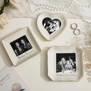 May include: Three decorative ceramic trays with gold trim, each featuring a black and white photograph. One is heart-shaped, one square, and one scalloped. Text on the trays reads "Bestie Forever," "Friends Forever," and "Long live friendship."