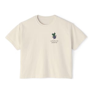 Puede incluir: Una camiseta de color crema con un gráfico de monstruo de dibujos animados y el texto "ya ha ha ya you found me".