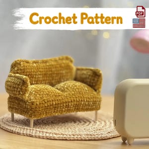 May include: A mustard yellow miniature sofa made of crocheted yarn with a textured surface, featuring two rounded armrests and a cushioned seat. The text Crochet Pattern is displayed at the top, accompanied by a PDF icon and a US flag graphic.