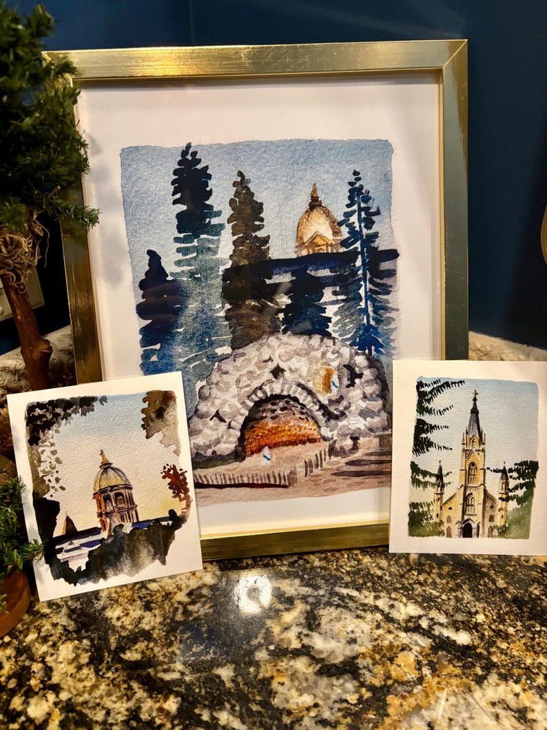 May include: Three watercolor paintings of buildings in a forest setting. The first painting shows a building with a golden dome, the second shows a stone archway, and the third shows a church with a tall steeple.