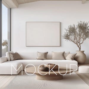 May include: A white sectional sofa with beige throw pillows sits in a minimalist living room with a large framed print on the wall, a wooden coffee table with decorative bowls, and a potted tree in the corner.