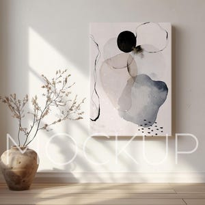 May include: Abstract art print with a white background and black, gray, and blue watercolor shapes. The print is framed and hanging on a white wall.