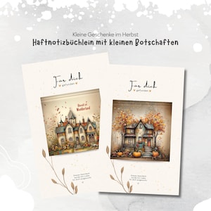 May include: Two rectangular sticky note booklets featuring cream-coloured covers with delicate brown line drawings of stems. Each cover displays the German text "Für dich gefunden" and "Dieses Geschenk wurde mit Liebe für dich ausgesucht" with illustrations of houses.