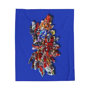 May include: A blue blanket featuring a colorful, detailed illustration of various robot-like figures. The robots are predominantly red, orange, blue, and silver, with intricate mechanical designs. The blanket is rectangular.