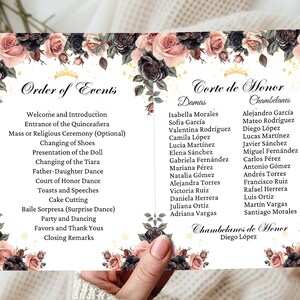 May include: A Quinceañera order of events card with a floral design featuring pink and black roses. The card lists the order of events for the celebration, including the entrance of the Quinceañera, changing of shoes, presentation of the doll, and more. The card also includes a list of the court of honor, with the names of the damas and chambelanes.