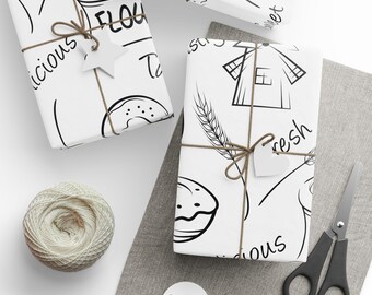 Op de afbeelding: Drie witte cadeaupapierontwerpen met zwarte lijntekeningen van een windmolen, tarwe, een donut, een kop koffie en de woorden "vers", "heerlijk", "meel" en "lekker".