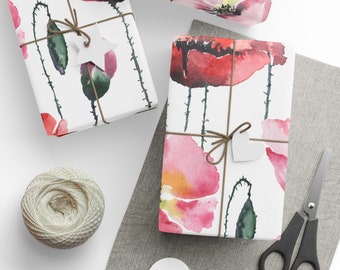 May include: Gift-wrapped boxes with watercolor poppy floral design. Each box is tied with twine and a paper tag. A ball of twine, scissors, and blank tags are also visible.