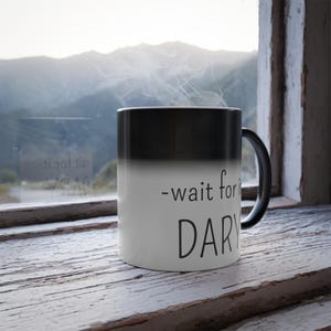 May include: Black and white color-changing mug with the text "wait for it... DARY" on the white side.