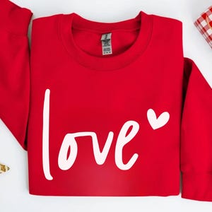 a red sweatshirt with the word love on it