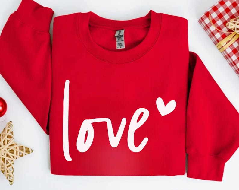 a red sweatshirt with the word love on it