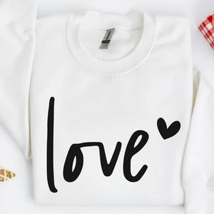a white shirt with the word love written on it